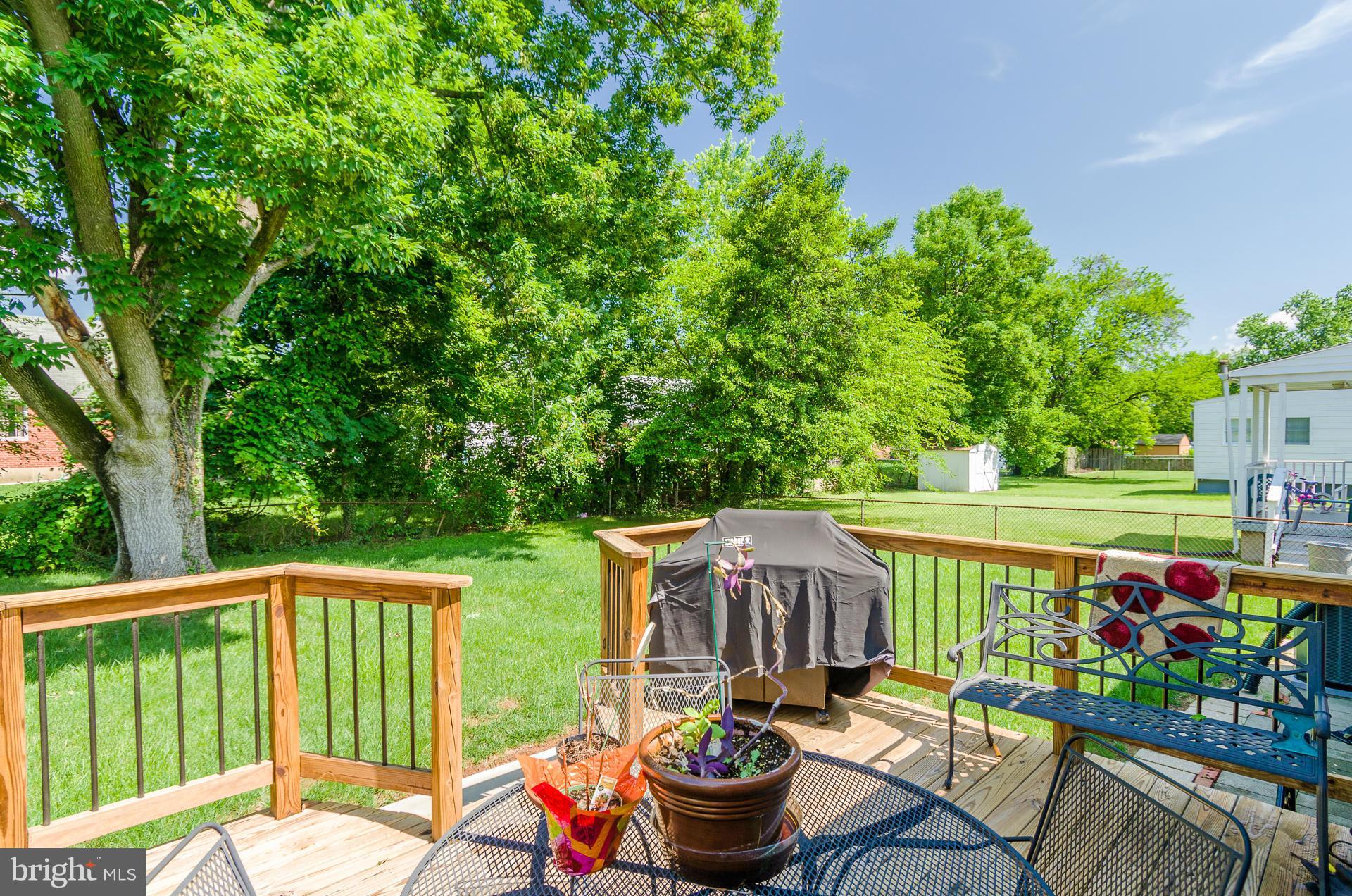 3522 Wild Cherry Road Baltimore, MD 21244 - Photo 25 of 30 a balcony with outdoor seating and trees in the background