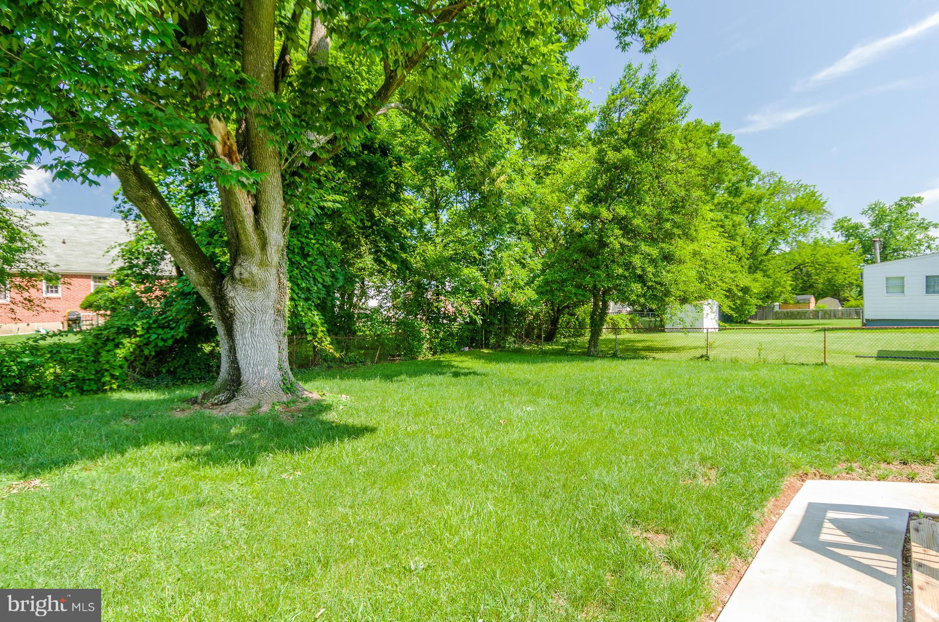 3522 Wild Cherry Road Baltimore, MD 21244 - Photo 27 of 30 a view of grassy field with benches