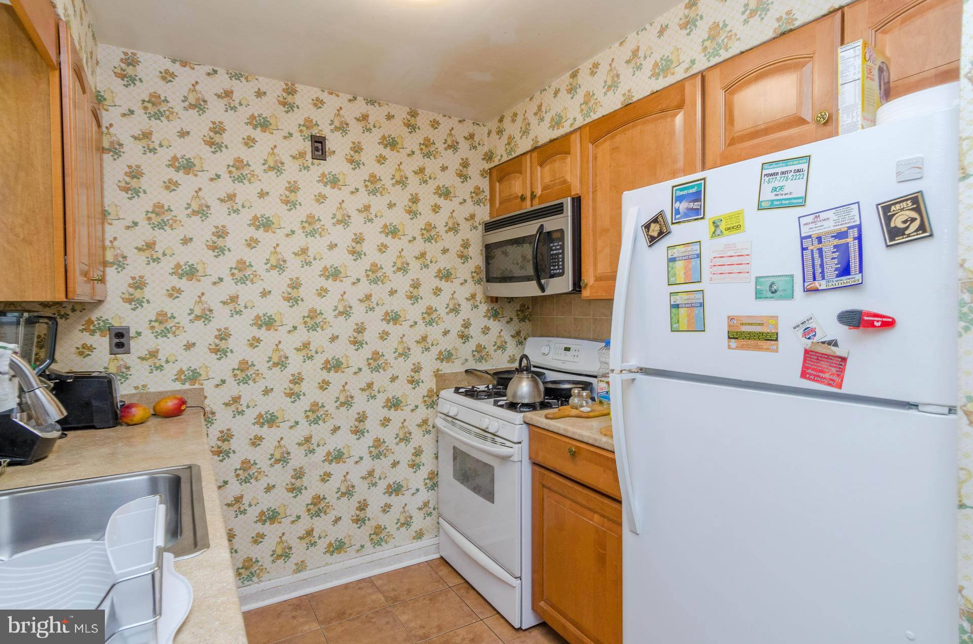 3522 Wild Cherry Road Baltimore, MD 21244 - Photo 6 of 30 a utility room with a refrigerator and a sink