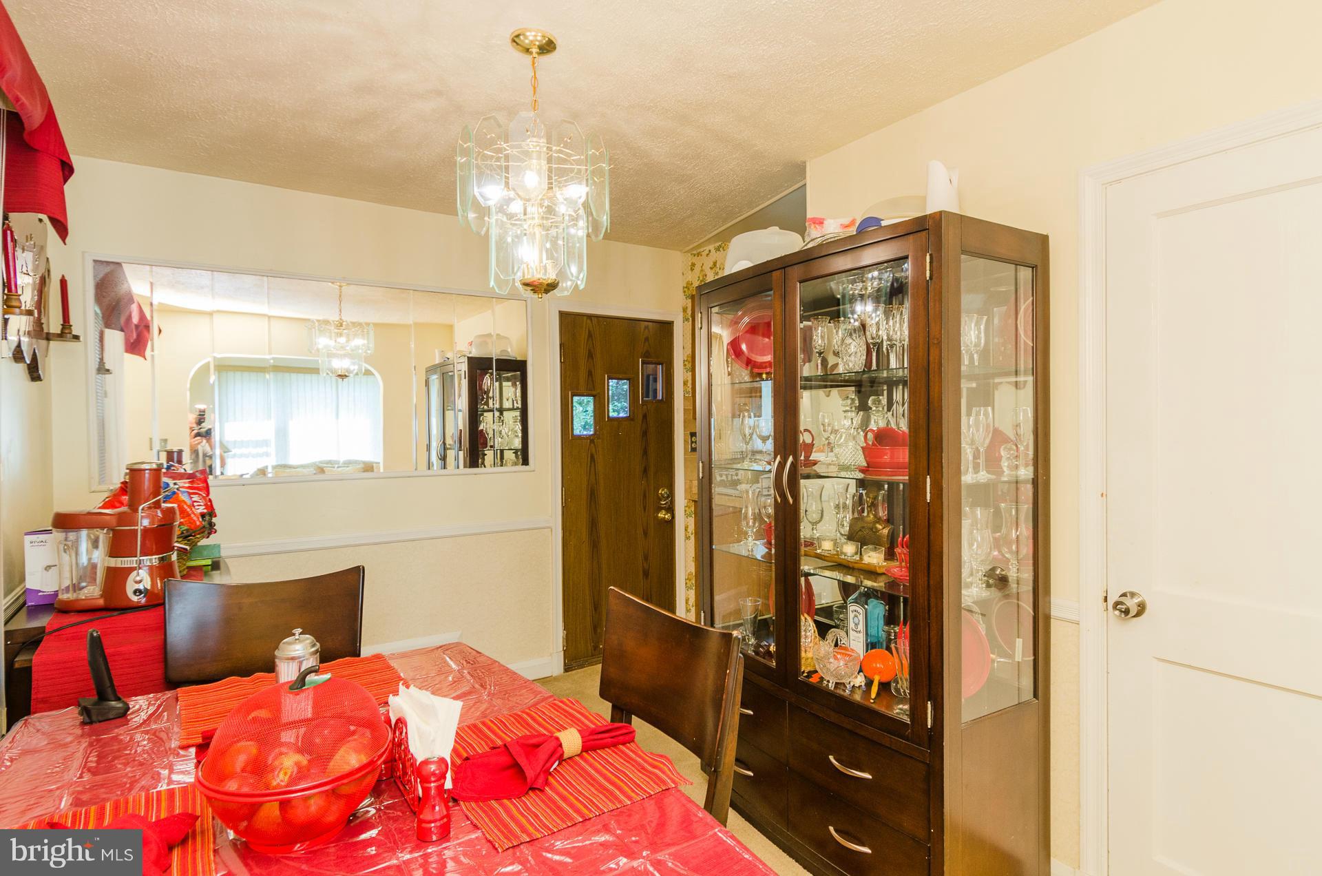 3522 Wild Cherry Road Baltimore, MD 21244 - Photo 9 of 30 a bedroom with a bed table and a chandelier