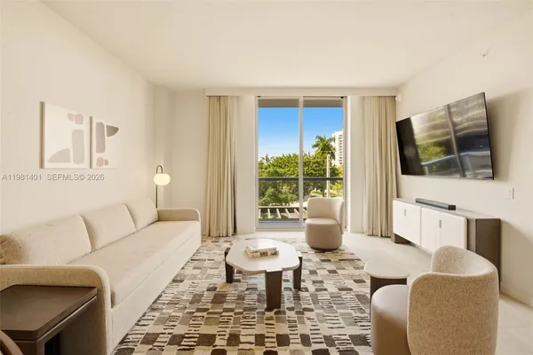 a living room with furniture and a flat screen tv
