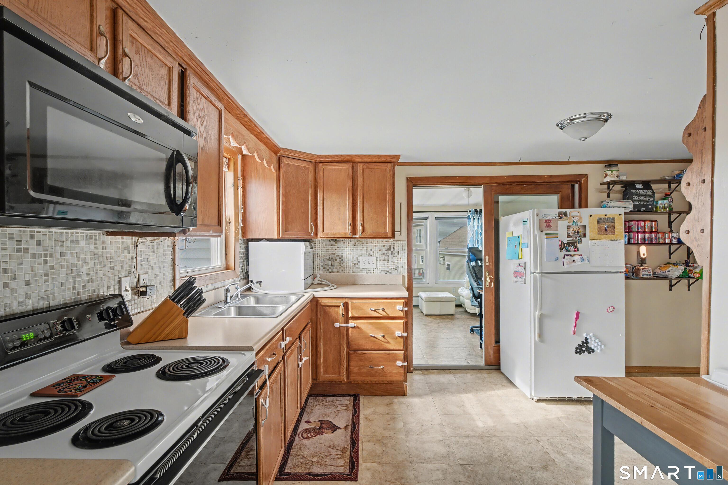 95 Kitemaug Road Montville, CT 06382 - Photo 14 of 24 a kitchen with stainless steel appliances a stove a sink and a refrigerator