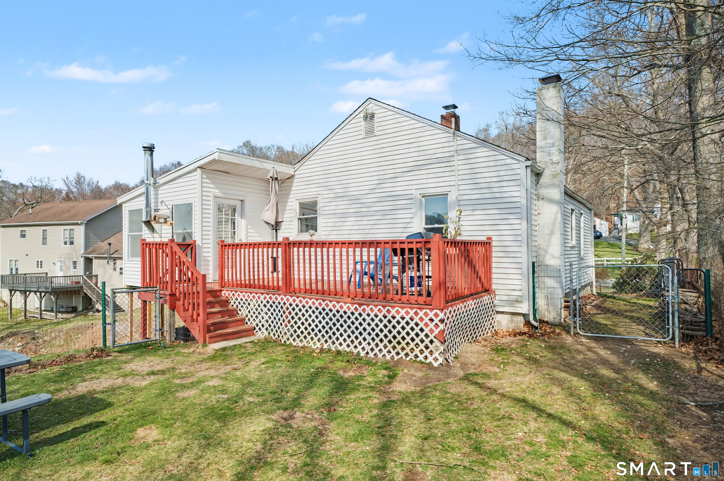 95 Kitemaug Road Montville, CT 06382 - Photo 18 of 24 a view of a house with a wooden deck and a yard