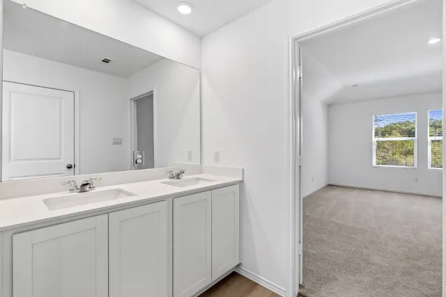 a white bath tub sitting next to a shower