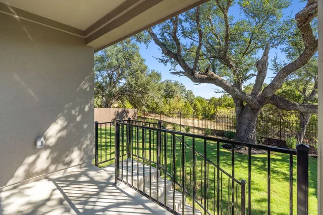 a backyard of a house with a yard and outdoor seating