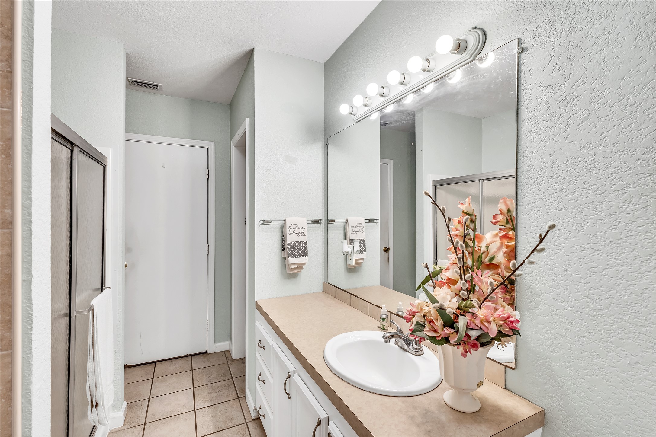 11909 Bluebonnet Lane Manchaca, TX 78652 - Photo 12 of 30 a bathroom with a sink double vanity and a mirror
