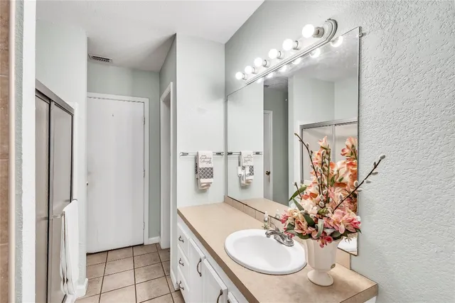 a bathroom with a sink double vanity and a mirror