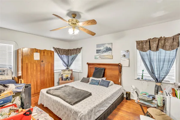 a bedroom with a bed a window and a chandelier