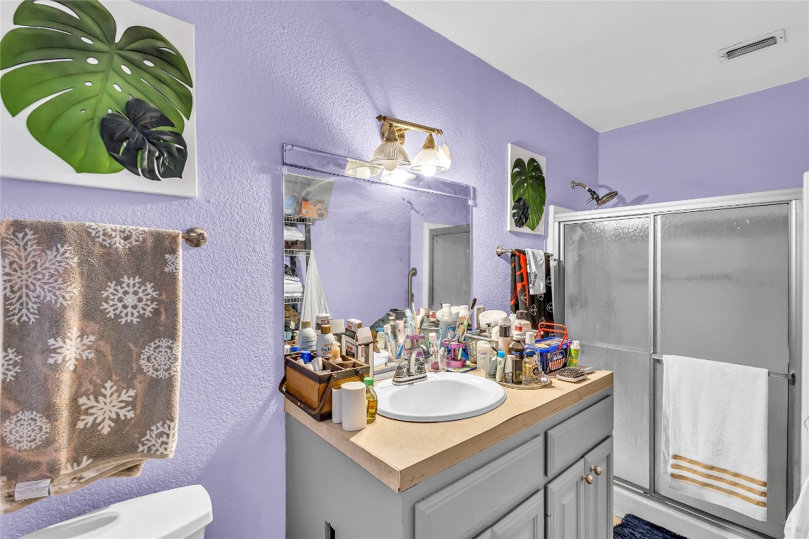 11909 Bluebonnet Lane Manchaca, TX 78652 - Photo 16 of 30 a bathroom with a sink and a mirror
