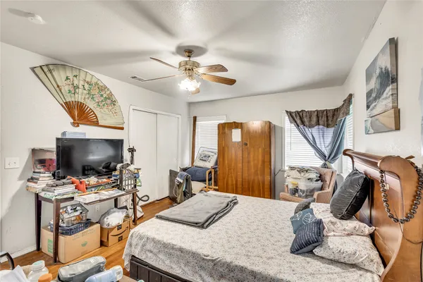 a bedroom with a bed and a flat screen tv