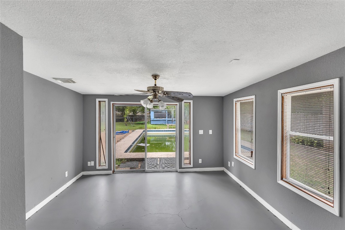 11909 Bluebonnet Lane Manchaca, TX 78652 - Photo 21 of 30 an empty room with wooden floor and windows