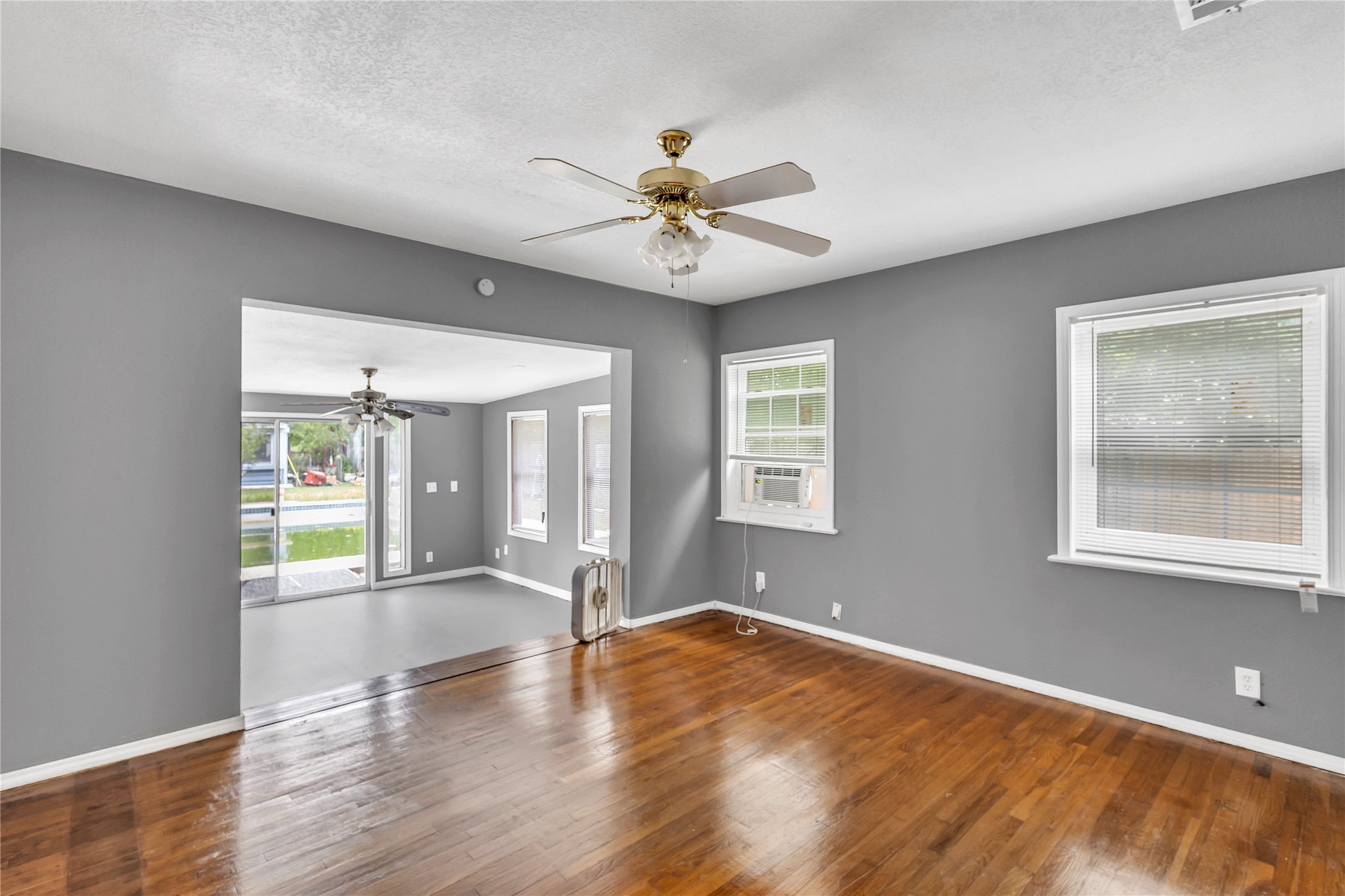 11909 Bluebonnet Lane Manchaca, TX 78652 - Photo 22 of 30 a view of an empty room with a window and wooden floor