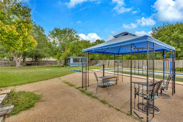 a view of a patio with a backyard