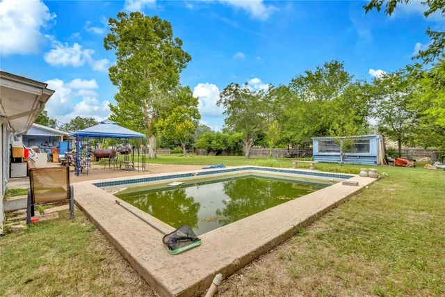 a view of swimming pool with chairs