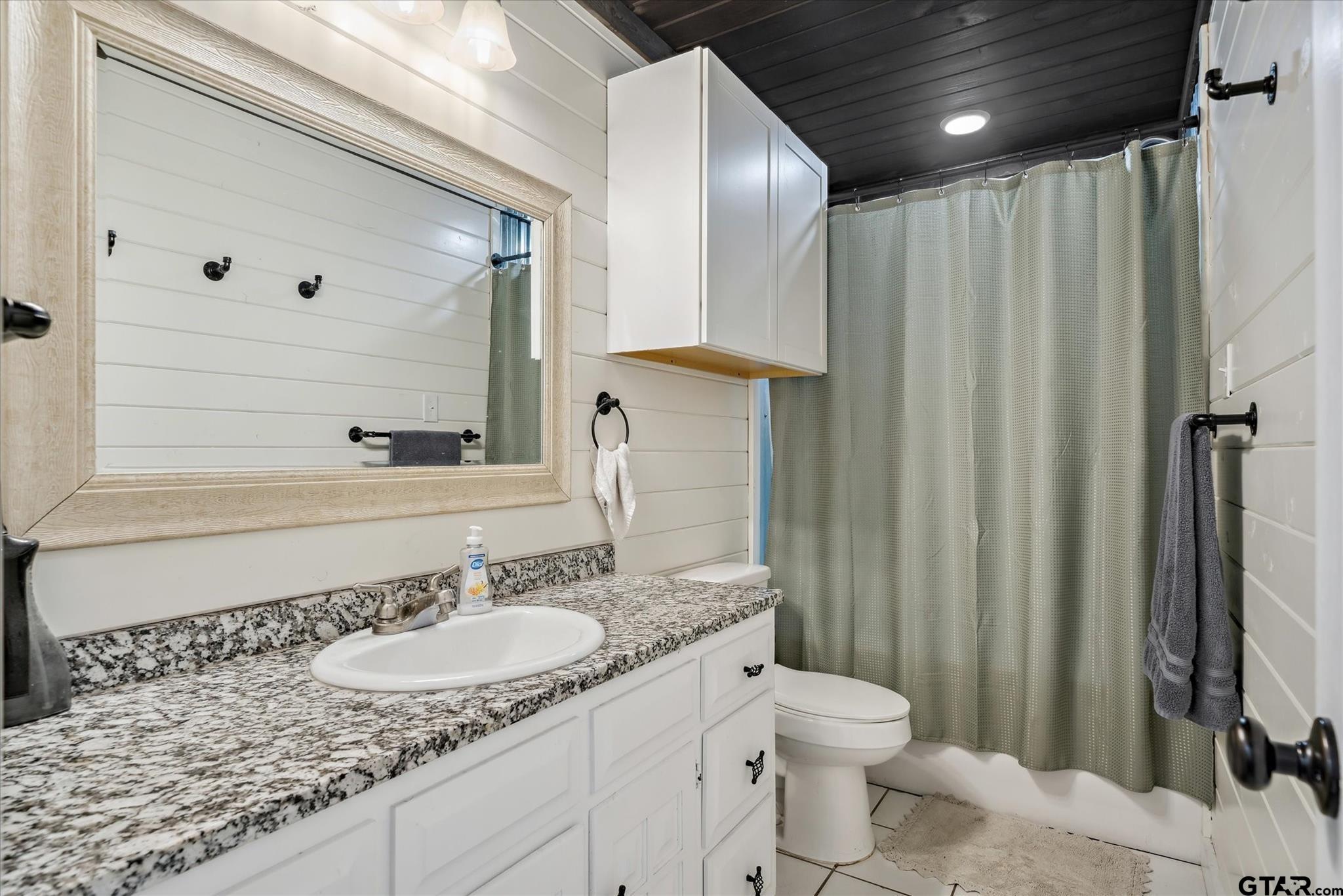 350 Alaska Street Van, TX 75790 - Photo 25 of 37 a bathroom with a granite countertop sink toilet and shower