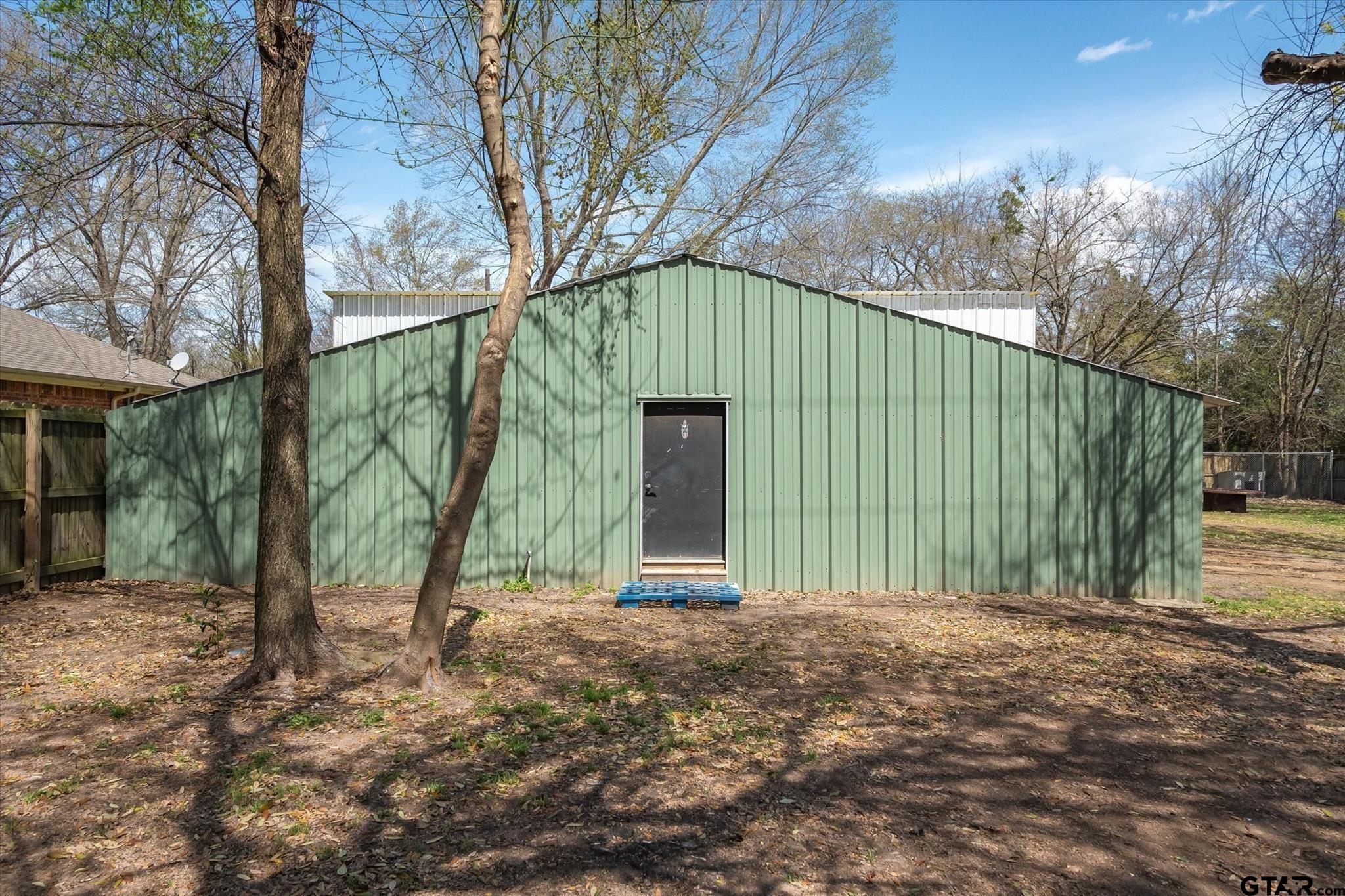 350 Alaska Street Van, TX 75790 - Photo 29 of 37 a view of a house with a backyard and trees