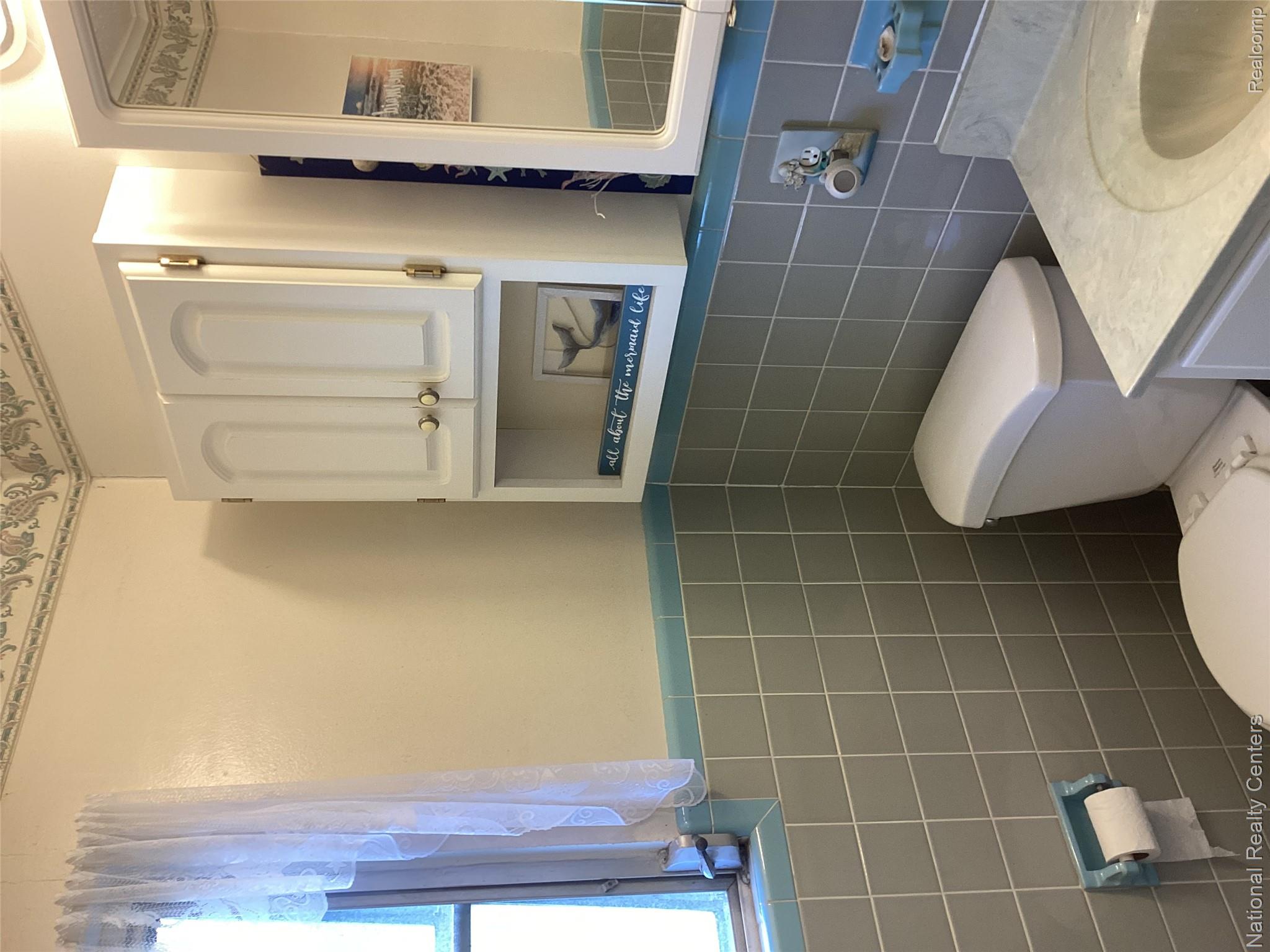 6024 Port Austin Road, Unit 5 Caseville, MI 48725 - Photo 25 of 56 Tiled bathroom