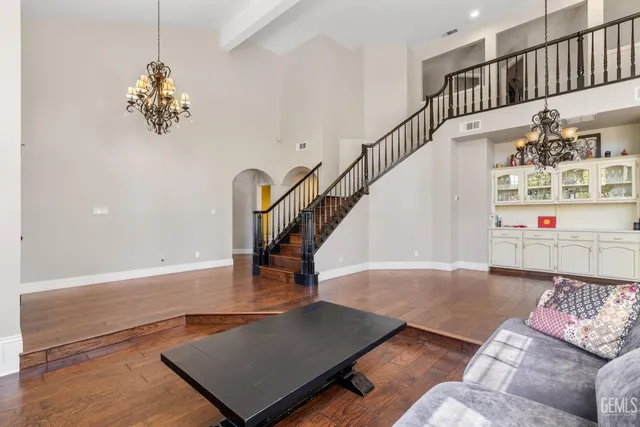 a view of a dining room with furniture and a chandelier