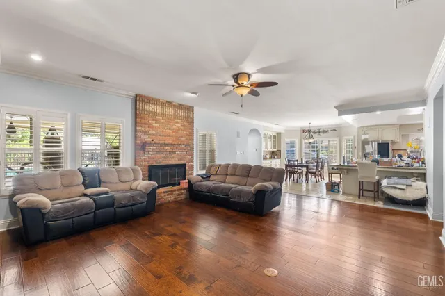 a kitchen with granite countertop white cabinets stainless steel appliances a sink and a window