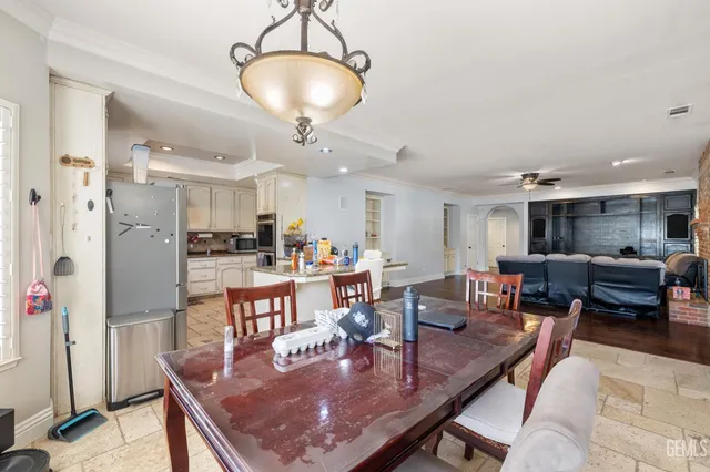 a view of a house with floor to ceiling windows and chairs