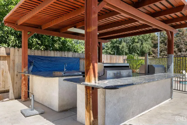 a view of a backyard with plants and tree