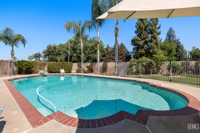 a living room with furniture and a painting on the wall