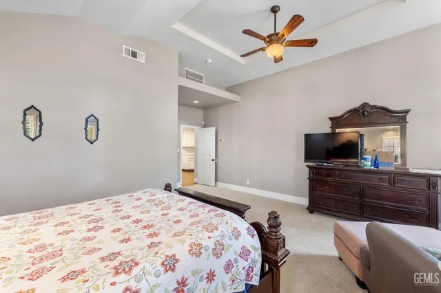 an empty room with closet and a ceiling fan