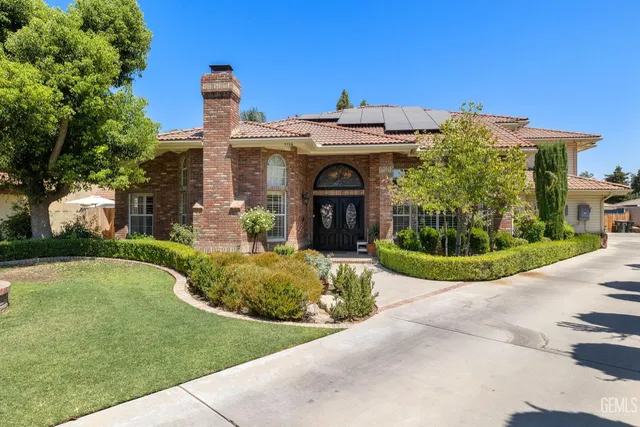 a front view of a house with garden