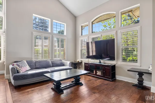 a living room with furniture and wooden floor