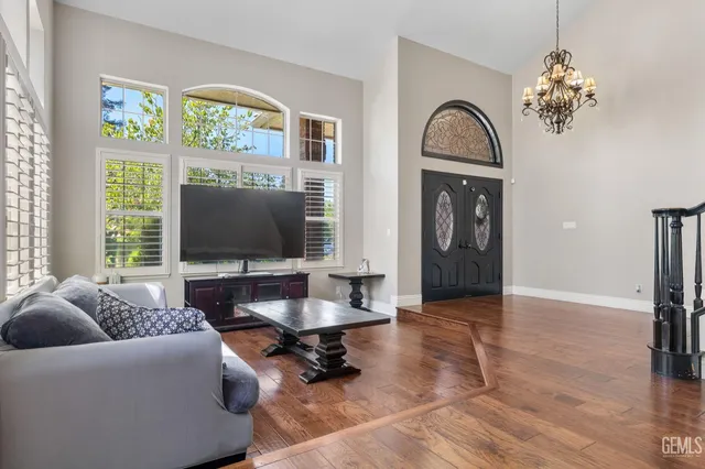 a view of a livingroom with furniture window wooden floor and windows