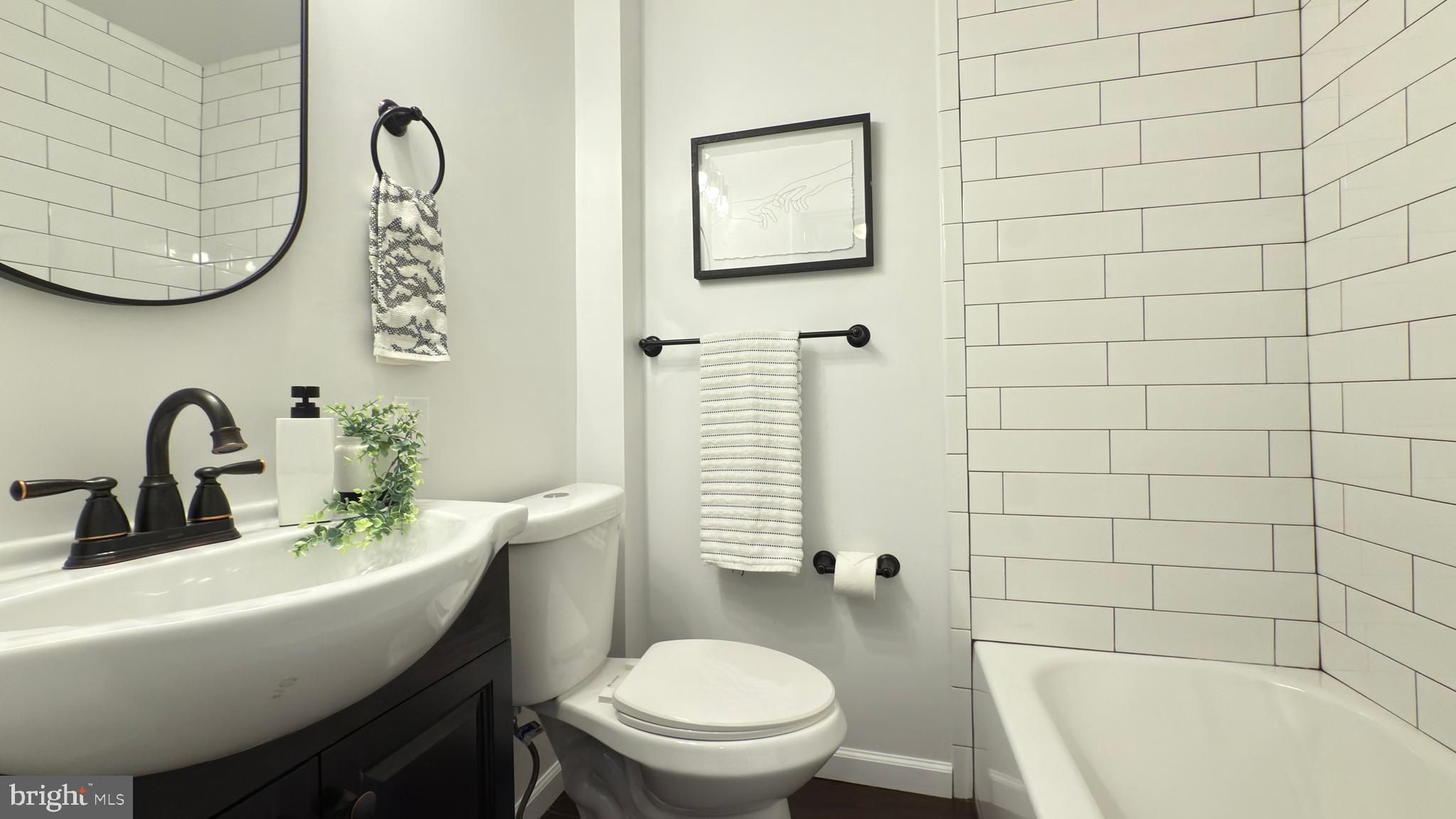 249 Hobart Avenue Hamilton, NJ 08629 - Photo 18 of 27 a bathroom with a sink a toilet and bathtub