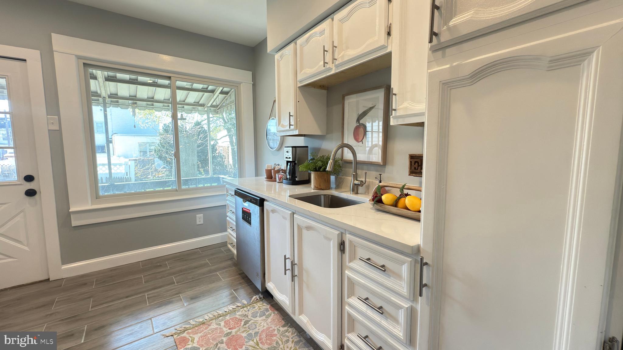 249 Hobart Avenue Hamilton, NJ 08629 - Photo 9 of 27 a kitchen with white cabinets and a window