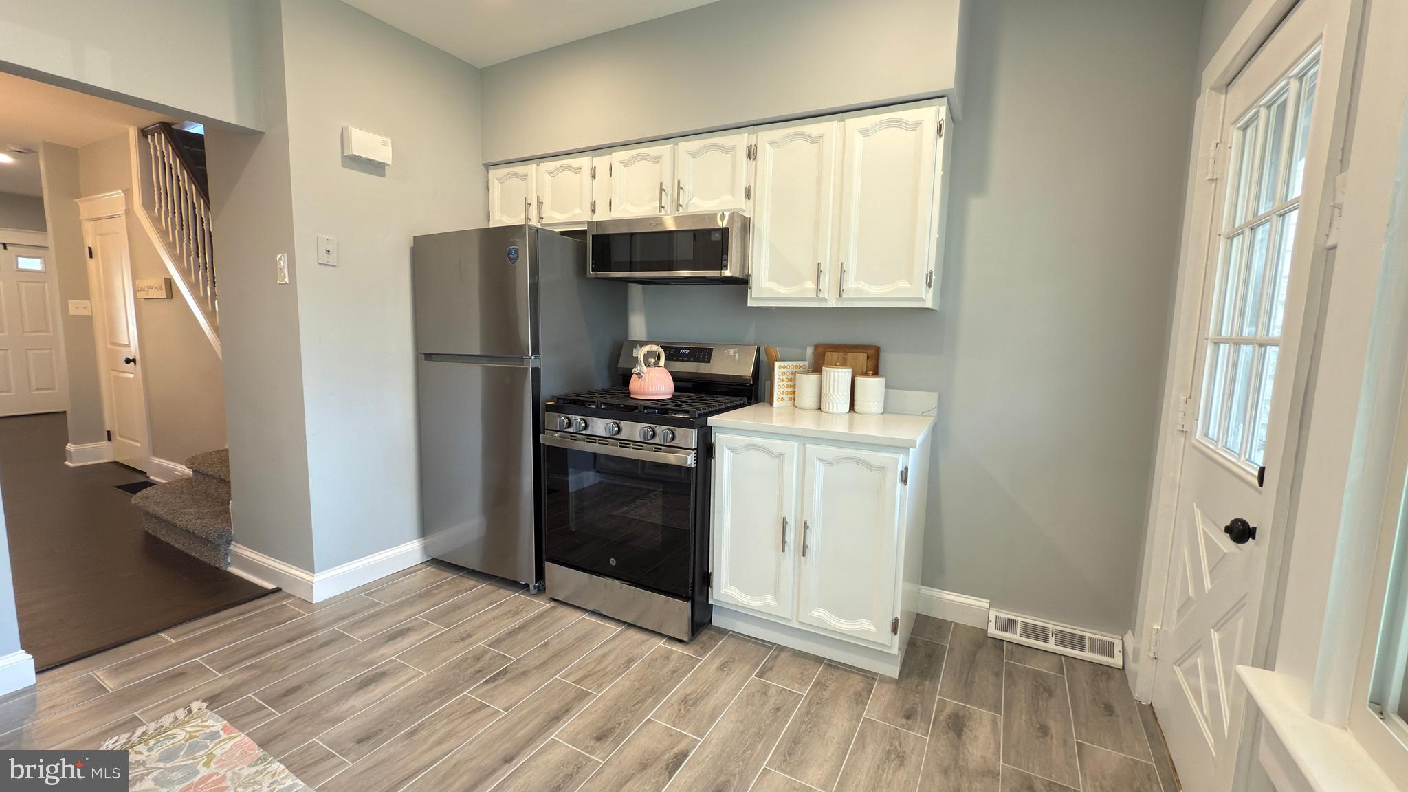 249 Hobart Avenue Hamilton, NJ 08629 - Photo 10 of 27 a kitchen with stainless steel appliances a refrigerator sink and microwave