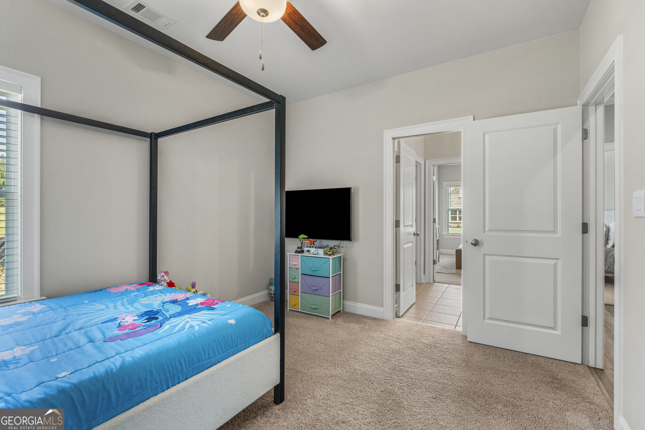 334 Orchard Drive Fortson, GA 31808 - Photo 33 of 48 a bedroom with a bed and a flat screen tv