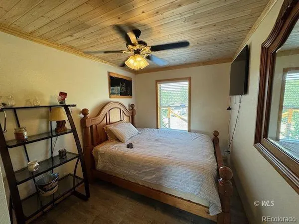 a bedroom with a bed next to a window