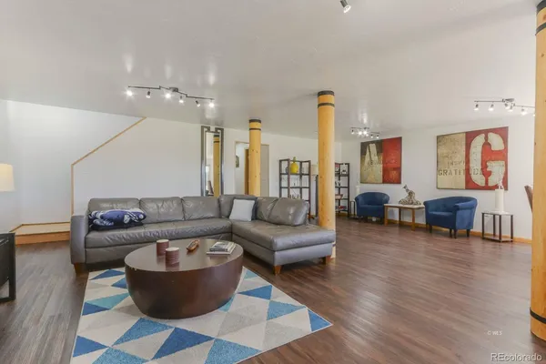 a living room with furniture or couch and a chandelier
