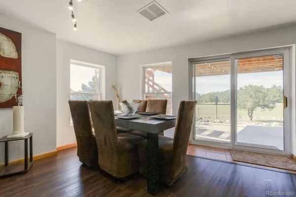 a view of a dining room with furniture window and wooden floor