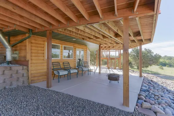 a view of a porch with chairs and backyard