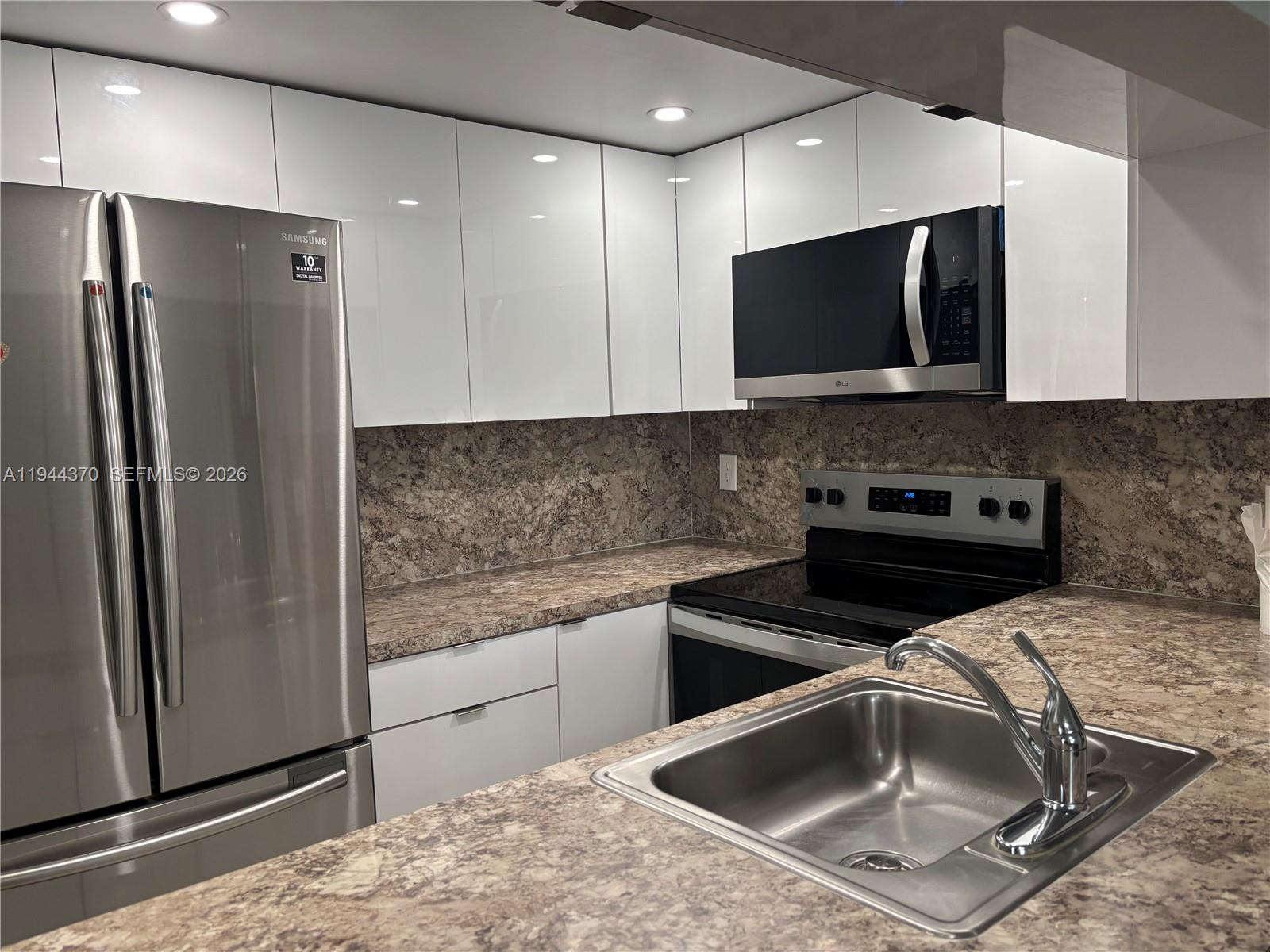a kitchen with a sink and a refrigerator