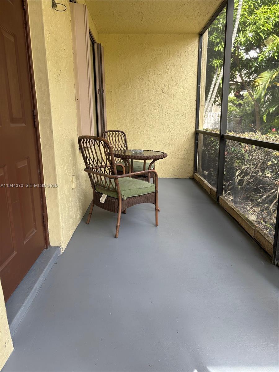 10023 Winding Lake Road, Unit 101 Sunrise, FL 33351 - Photo 17 of 19 a view of staircase with railing and white walls