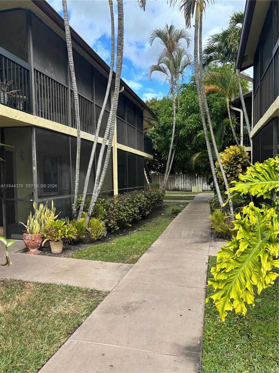 10023 Winding Lake Road, Unit 101 Sunrise, FL 33351 - Photo 18 of 19 a backyard of a house with lots of green space