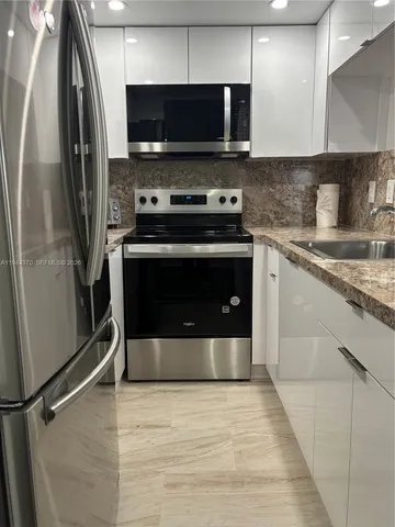 a kitchen with a stove and a refrigerator