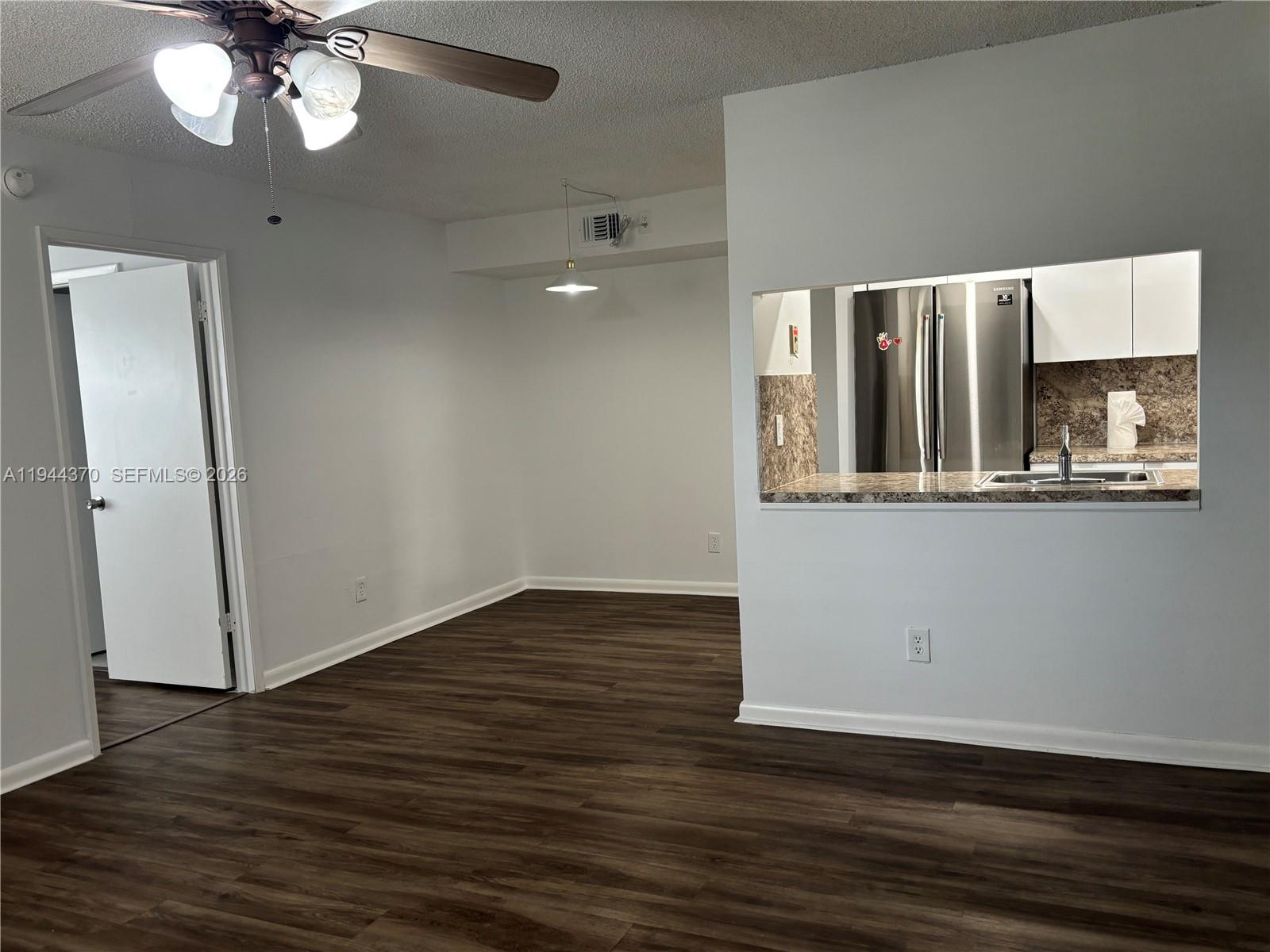 10023 Winding Lake Road, Unit 101 Sunrise, FL 33351 - Photo 5 of 19 wooden floor in an empty room