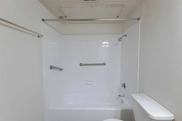 a bathroom with a bathtub and toilet