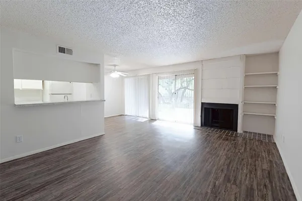 a view of a room with wooden floor and brick walls