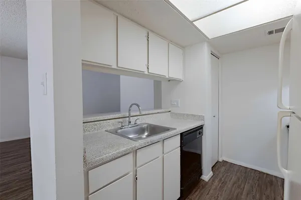 a kitchen with a sink and cabinets