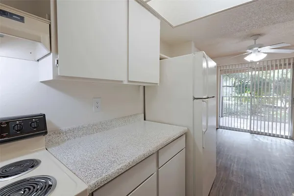 a kitchen with a sink a refrigerator and a stove