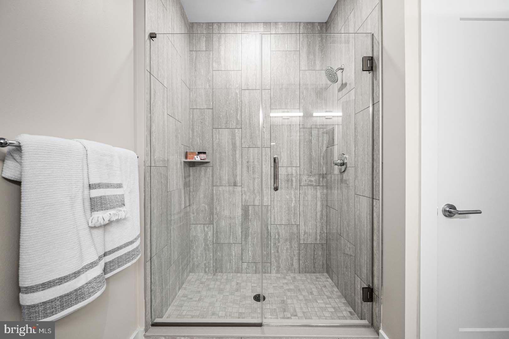 703 Rice Boulevard, Unit 103 Exton, PA 19341 - Photo 7 of 10 Sleek glass shower with modern tiles.