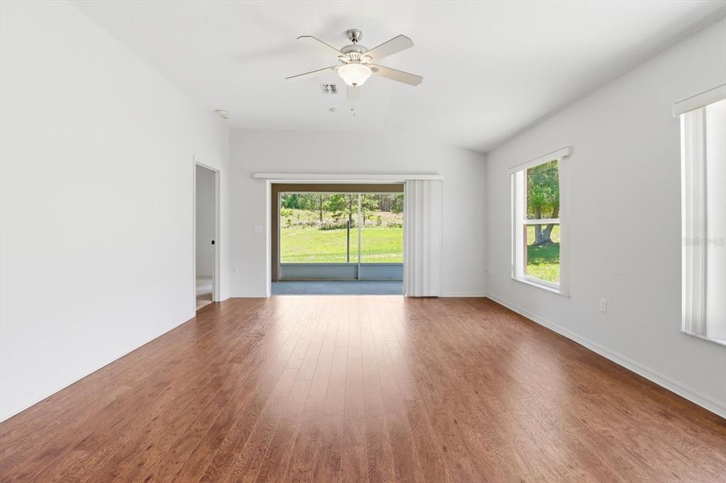 826 West Cockatiel Loop Hernando, FL 34442 - Photo 4 of 40 wooden floor in an empty room with a window