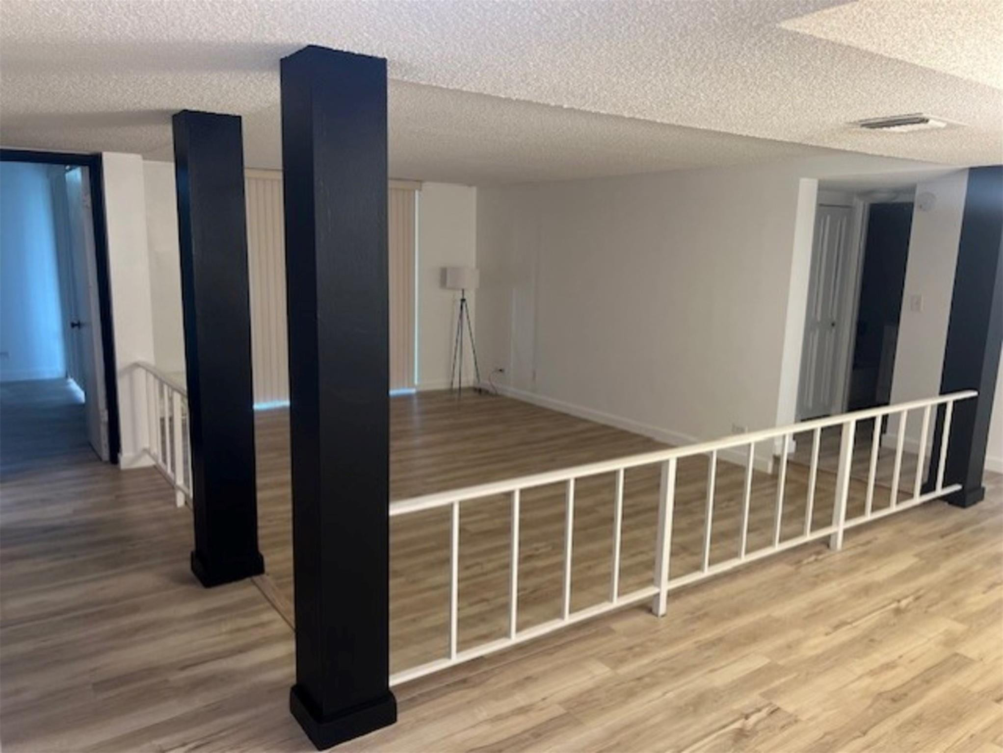 3720 Inverrary Drive, Unit 1T Lauderhill, FL 33319 - Photo 5 of 36 a view of entryway with wooden floor
